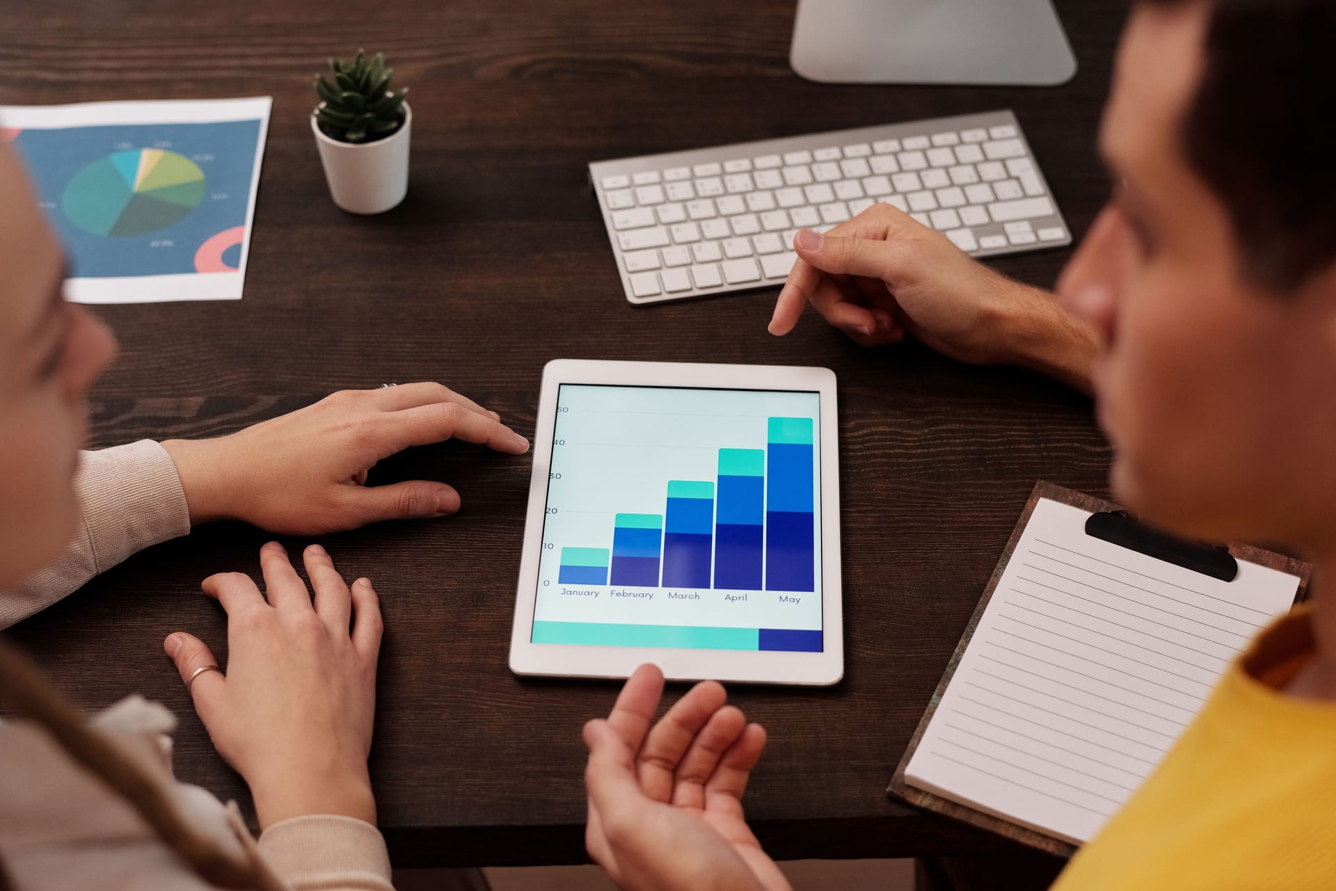 Team reviewing performance metrics on a tablet