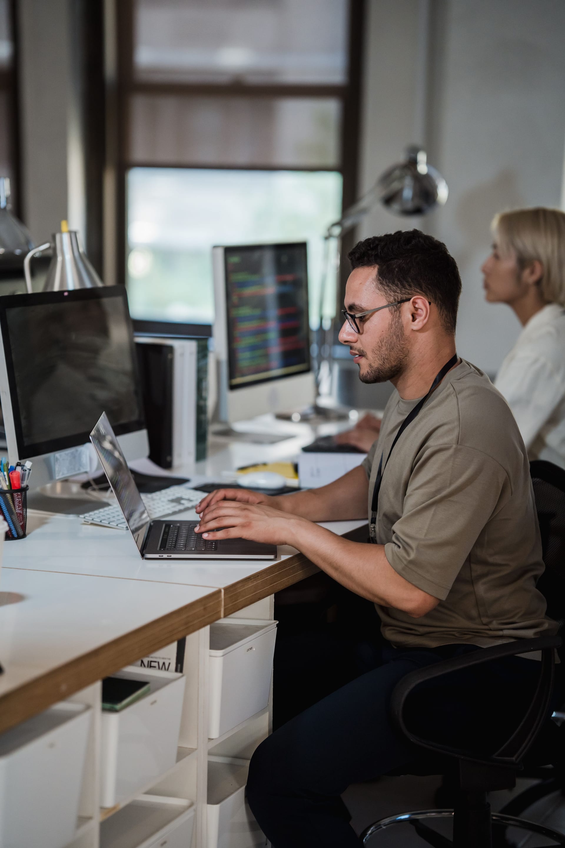 Developer providing ongoing technical support at a workstation
